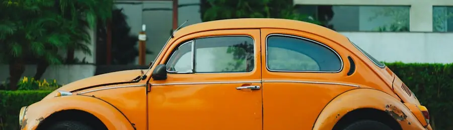 A sun-faded orange Beetle parked at the curb