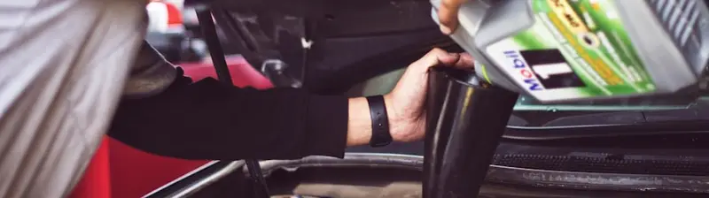 A car on a lift during an emissions inspection