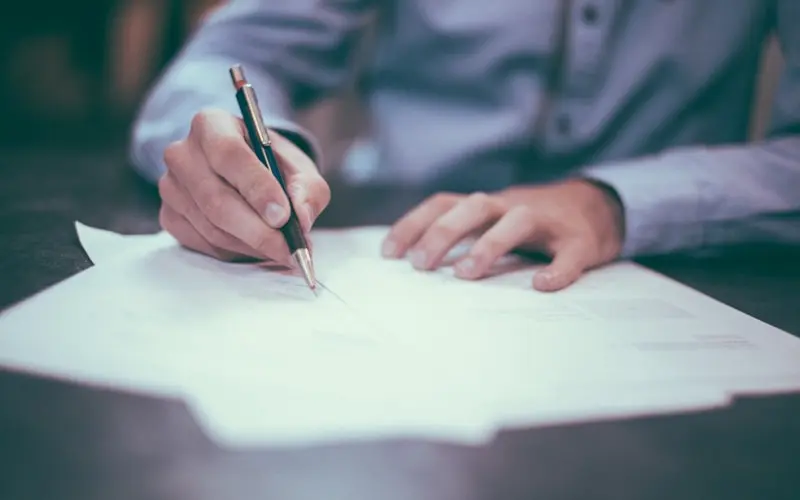 Signing the paperwork to sell a car in St. Louis